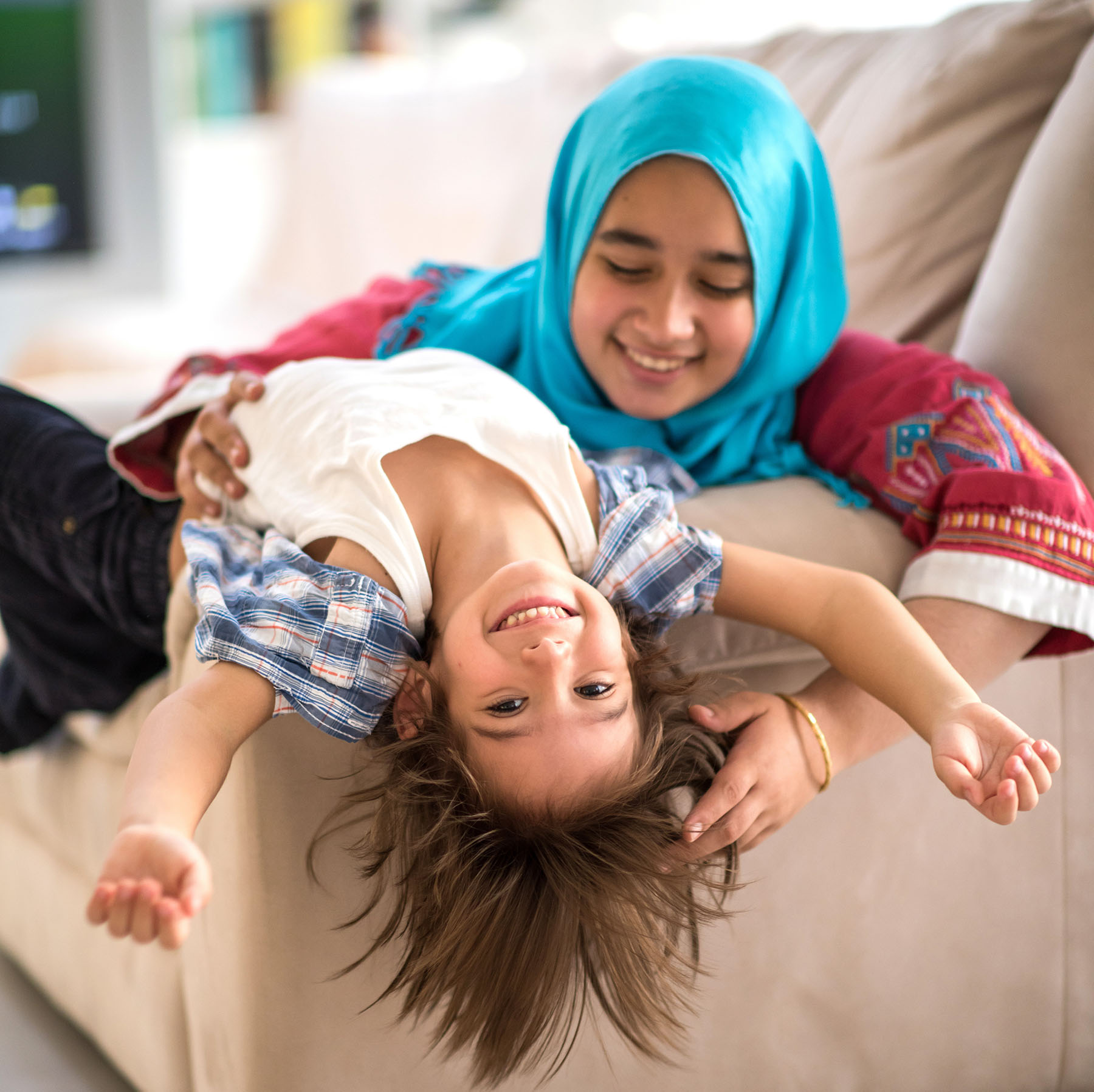 Mother and child playing on couch